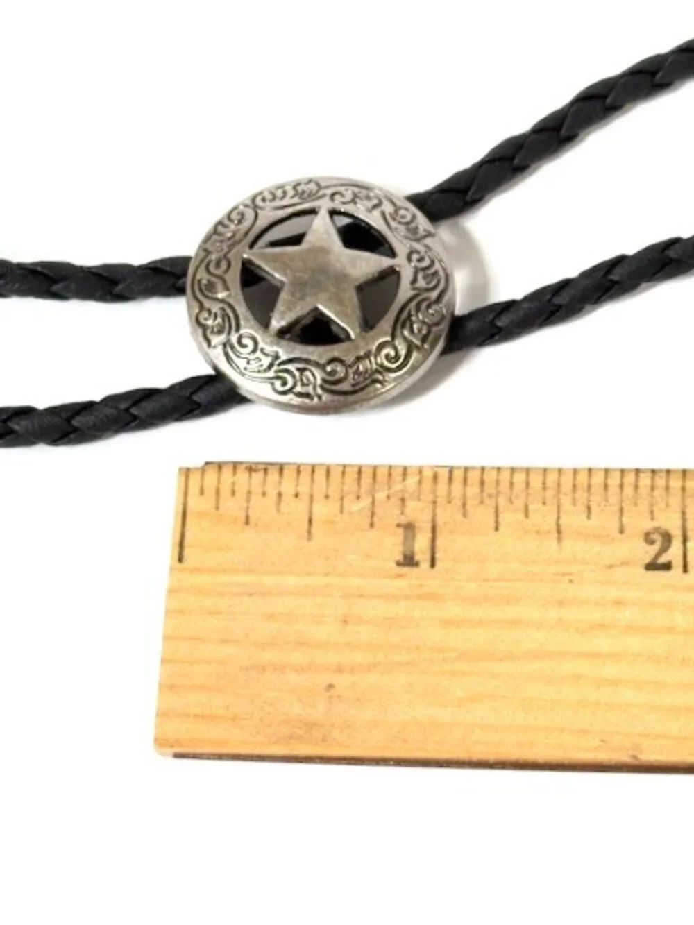 Silver-tone sheriff star and black cord western cowboy bolo tie.